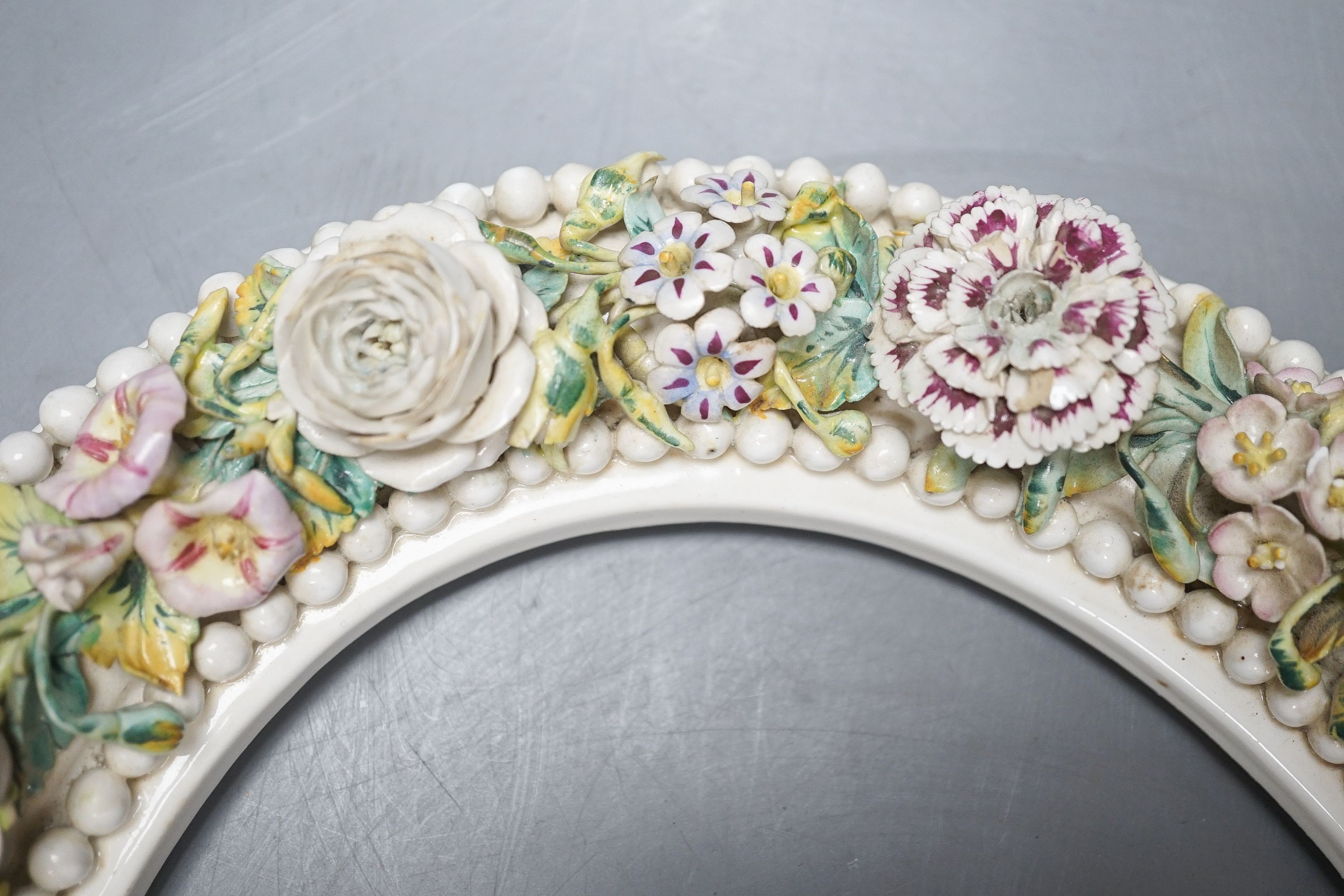 A 19th century English porcelain floral encrusted oval frame 32cm